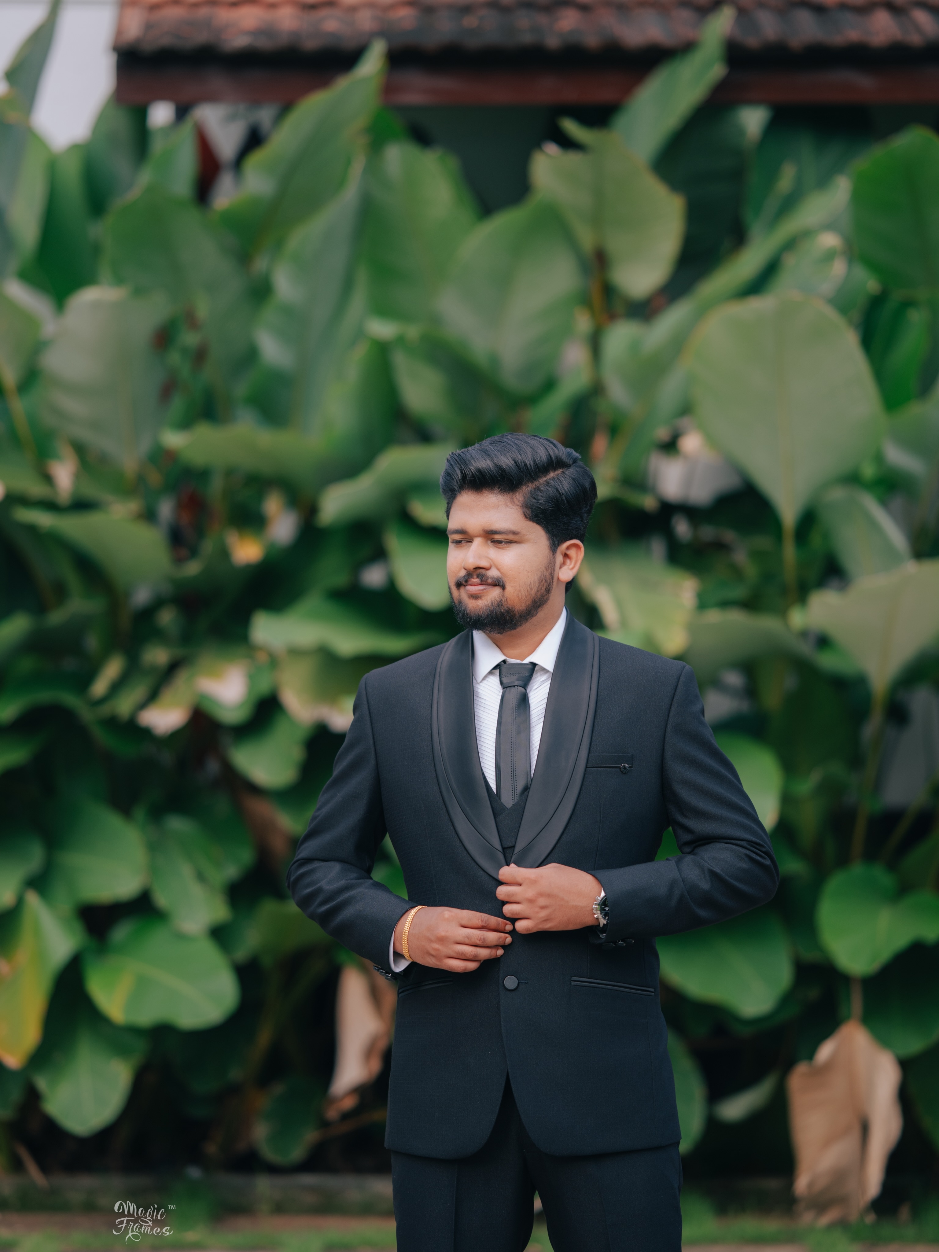 Groom portrait against tropical greenery